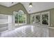 A sunroom with large windows and a vaulted ceiling, bringing nature inside at 530 Georgian Hills Dr, Lawrenceville, GA 30045