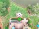 Overhead view of backyard with fire pit, deck, screened porch, mature landscaping, and lake at 1346 Wind Chime Ct, Lawrenceville, GA 30045