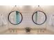 Bathroom featuring double sinks, modern fixtures, round mirrors, and shiplap at 1346 Wind Chime Ct, Lawrenceville, GA 30045