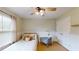 Bedroom features a comfortable bed, window, and desk at 1346 Wind Chime Ct, Lawrenceville, GA 30045