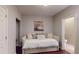 Cozy bedroom featuring a comfortable daybed, wood floors, and an attached half-bath at 1346 Wind Chime Ct, Lawrenceville, GA 30045
