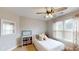 Well-lit bedroom featuring a large window and dresser with decorative accents at 1346 Wind Chime Ct, Lawrenceville, GA 30045