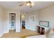 Well-lit bedroom featuring a closet and a small dresser with decorative accents at 1346 Wind Chime Ct, Lawrenceville, GA 30045