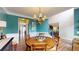 Dining room with teal accent wall, chandelier, and hardwood floors create a inviting space for meals at 1346 Wind Chime Ct, Lawrenceville, GA 30045