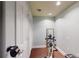 Exercise room featuring white walls and hardwood floors with stationary bike and weights at 1346 Wind Chime Ct, Lawrenceville, GA 30045