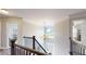 Bright hallway with chandelier over the home's entry and staircase at 1346 Wind Chime Ct, Lawrenceville, GA 30045