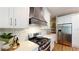 Modern kitchen with stainless steel appliances, white cabinets, and an eat-in bar at 1346 Wind Chime Ct, Lawrenceville, GA 30045