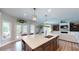 Island kitchen with a large island, stainless steel appliances, and an open floor plan at 1346 Wind Chime Ct, Lawrenceville, GA 30045