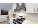 Modern kitchen with stainless steel range hood, and patterned backsplash at 1346 Wind Chime Ct, Lawrenceville, GA 30045