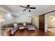 Spacious living room with hardwood floors, comfortable sectional sofa, and modern ceiling fan at 1346 Wind Chime Ct, Lawrenceville, GA 30045