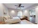 Bright main bedroom featuring a ceiling fan, sitting area, and connecting room at 1346 Wind Chime Ct, Lawrenceville, GA 30045