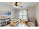 Office featuring stylish desk, neutral chair, floral curtains, ceiling fan and decor at 1346 Wind Chime Ct, Lawrenceville, GA 30045