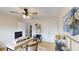 Office featuring a desk, storage shelves, double closet, ceiling fan and an adjacent bathroom at 1346 Wind Chime Ct, Lawrenceville, GA 30045