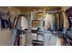 Well-organized walk-in closet with ample hanging space and shelving for optimal storage solutions at 1346 Wind Chime Ct, Lawrenceville, GA 30045