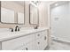 Modern bathroom featuring double vanity with marble countertop and a tiled shower with glass door at 2080 Cactus Ln, Cumming, GA 30040