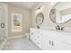 Bright bathroom featuring double sinks, black fixtures, and marble tile flooring at 2080 Cactus Ln, Cumming, GA 30040