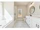 Bright bathroom boasts double vanity, marble floors, soaking tub, and glass enclosed shower at 2080 Cactus Ln, Cumming, GA 30040