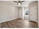 A bright bedroom with ceiling fan and two closets features vinyl wood flooring at 2080 Cactus Ln, Cumming, GA 30040