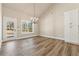Bright dining area with a modern chandelier, wooden floors, and backyard views at 2080 Cactus Ln, Cumming, GA 30040