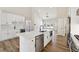 Modern kitchen features white cabinets, an island with quartz countertop, and stainless steel appliances at 2080 Cactus Ln, Cumming, GA 30040