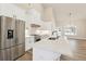 Modern kitchen with a stainless steel refrigerator, white cabinetry, and quartz countertops at 2080 Cactus Ln, Cumming, GA 30040