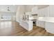 Bright, open-concept kitchen boasts vaulted ceiling, white cabinets and island, and stainless steel appliances at 2080 Cactus Ln, Cumming, GA 30040