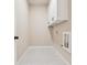The well lit laundry room has white cabinets and includes hookups for the washer and dryer at 2080 Cactus Ln, Cumming, GA 30040