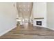 This open concept space features hardwood floors, a fireplace, tall ceilings, and access to the kitchen at 2080 Cactus Ln, Cumming, GA 30040