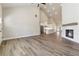 This open concept space features hardwood floors, a fireplace, tall ceilings, and access to the kitchen at 2080 Cactus Ln, Cumming, GA 30040