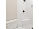 Bright white tiled shower includes a built-in bench, and black shower head and handle at 2080 Cactus Ln, Cumming, GA 30040
