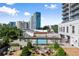 Aerial view features a community pool and lounging area and fire pit at 2277 Peachtree Ne Rd # 302, Atlanta, GA 30309