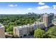 High-rise buildings overlooking a dense canopy of trees and the city skyline at 2277 Peachtree Ne Rd # 302, Atlanta, GA 30309