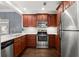 Modern kitchen with stainless steel appliances, white counters and dark wood cabinets at 2277 Peachtree Ne Rd # 302, Atlanta, GA 30309