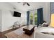 Cozy living room features a fireplace, a balcony, neutral tones and tons of natural light at 2277 Peachtree Ne Rd # 302, Atlanta, GA 30309