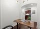 An office area with white walls and an adjustable desk with an open view to the kitchen at 2277 Peachtree Ne Rd # 302, Atlanta, GA 30309