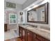 Elegant bathroom with granite countertops, dark wood cabinetry, and a large framed mirror at 5804 Fairwood Nw Cir, Acworth, GA 30101