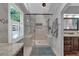 Modern bathroom featuring a large shower, window with shutters, and tile surround at 5804 Fairwood Nw Cir, Acworth, GA 30101