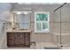 Bathroom with a glass-enclosed shower, updated vanity, and natural light at 5804 Fairwood Nw Cir, Acworth, GA 30101