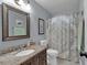 This bathroom features a granite countertop and a decorative shower curtain at 5804 Fairwood Nw Cir, Acworth, GA 30101