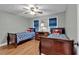 Bedroom featuring hardwood floors, twin beds, and matching wood furniture at 5804 Fairwood Nw Cir, Acworth, GA 30101