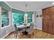 Cozy breakfast nook with large windows overlooking lush greenery and wood flooring at 5804 Fairwood Nw Cir, Acworth, GA 30101