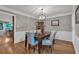 Traditional dining room with hardwood floors, wainscoting, and a modern chandelier at 5804 Fairwood Nw Cir, Acworth, GA 30101