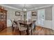 Dining room featuring hardwood floors, wainscoting, shuttered windows, and updated lighting fixture at 5804 Fairwood Nw Cir, Acworth, GA 30101