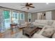 Comfortable living room with hardwood floors, large windows, and access to outdoor deck at 5804 Fairwood Nw Cir, Acworth, GA 30101