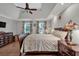 Bright main bedroom featuring hardwood floors, a ceiling fan, and matching nightstands at 5804 Fairwood Nw Cir, Acworth, GA 30101