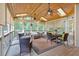 Enclosed porch featuring multiple seating areas, ceiling fans, skylights, and wooded backyard view at 5804 Fairwood Nw Cir, Acworth, GA 30101