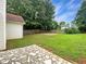 Lush backyard with green lawn, wooden fence, and mature trees offering privacy and space for outdoor activities at 1792 Portwest Way, Hampton, GA 30228