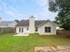 Fenced-in backyard with a patio, chimney, and an expansive lawn at 1792 Portwest Way, Hampton, GA 30228