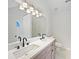 Bathroom with double sinks, wood vanity, and modern fixtures at 1792 Portwest Way, Hampton, GA 30228