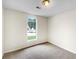 Bright bedroom with large arched window providing natural light, perfect for relaxation at 1792 Portwest Way, Hampton, GA 30228